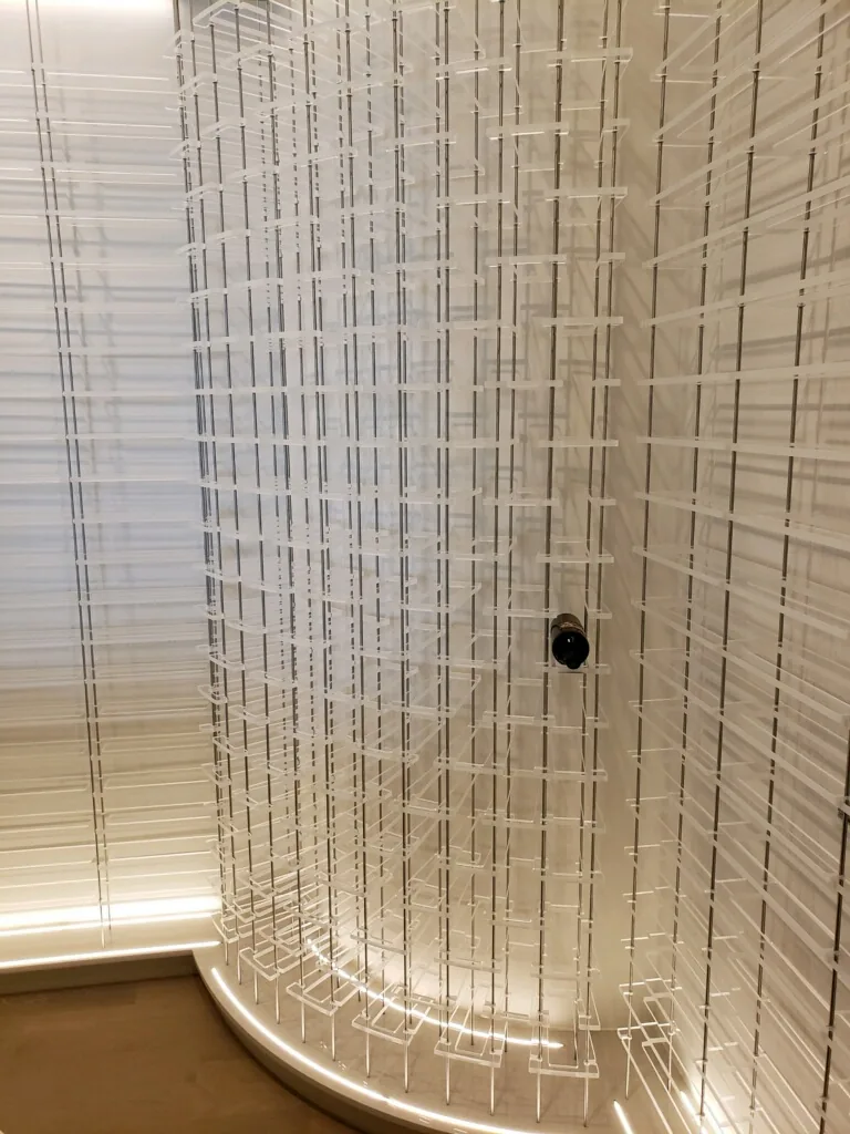 Bennett cellar: clear acrylic cradles with vertical stainless steel rods