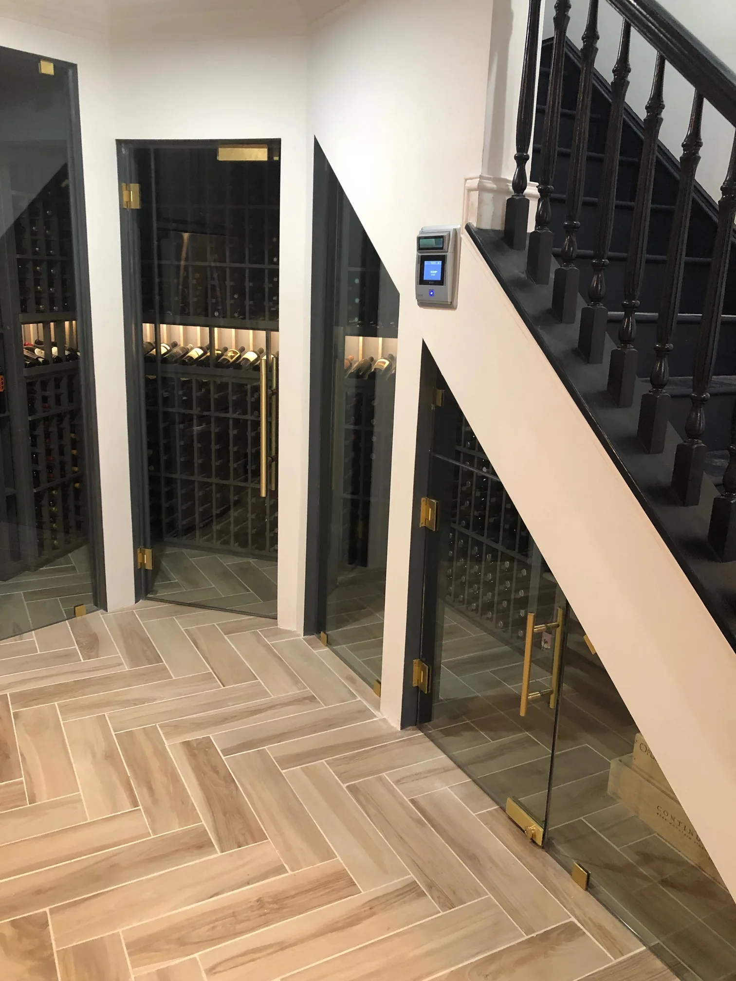 Gray-stained alder racking with LED lighting in the Vin Cave cellar